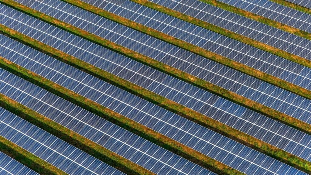 Bifacial solar panel installation with elevated mounting, reflective surface preparation, and optimal tilt and spacing for maximum efficiency