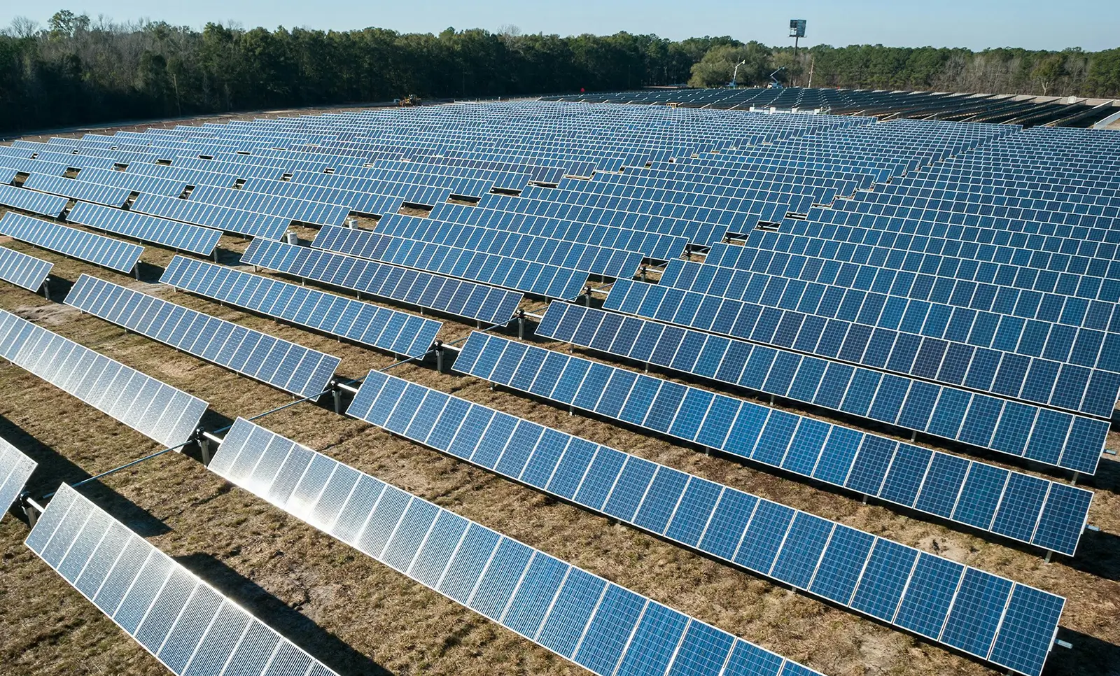 Rows of ground mounted solar panels installed across open land