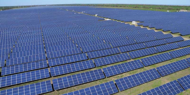 Extensive solar power plant with rows of panels installed on open land
