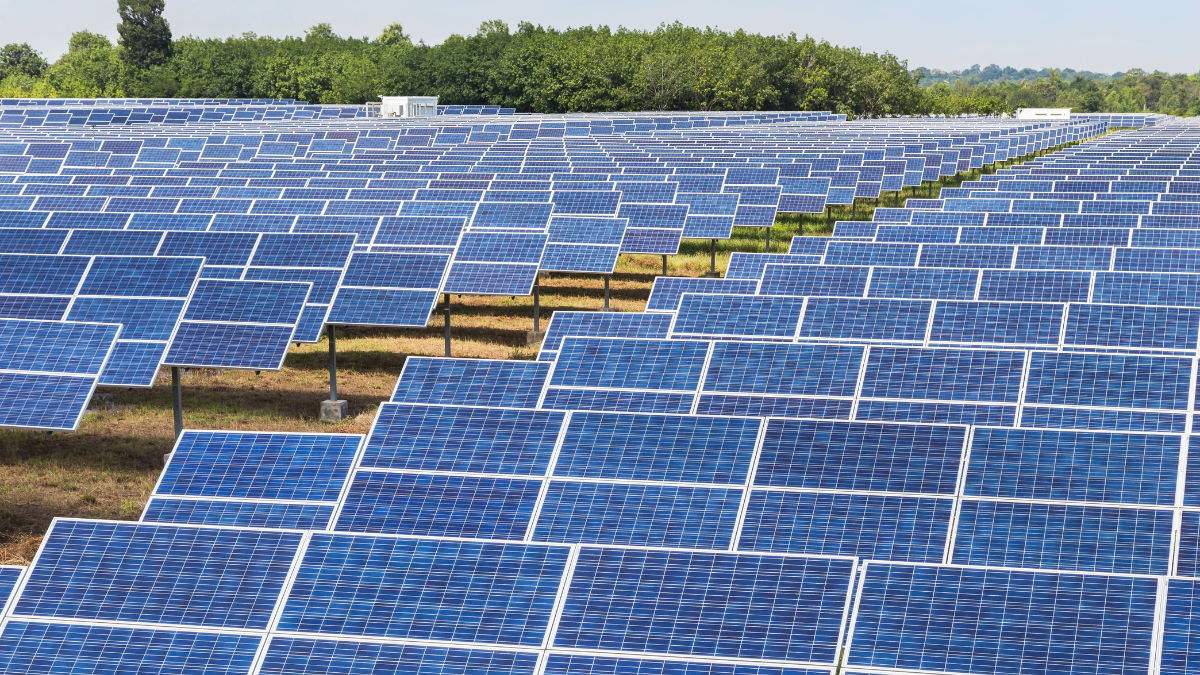 Ground mounted solar panels installed across open land under RESCO solar model